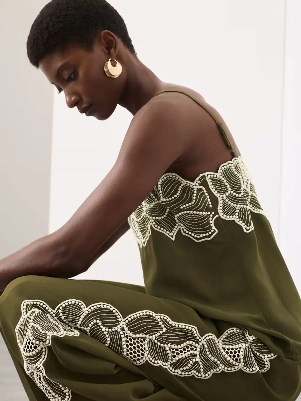 Woman wearing a green floral-embroidered top with matching trousers