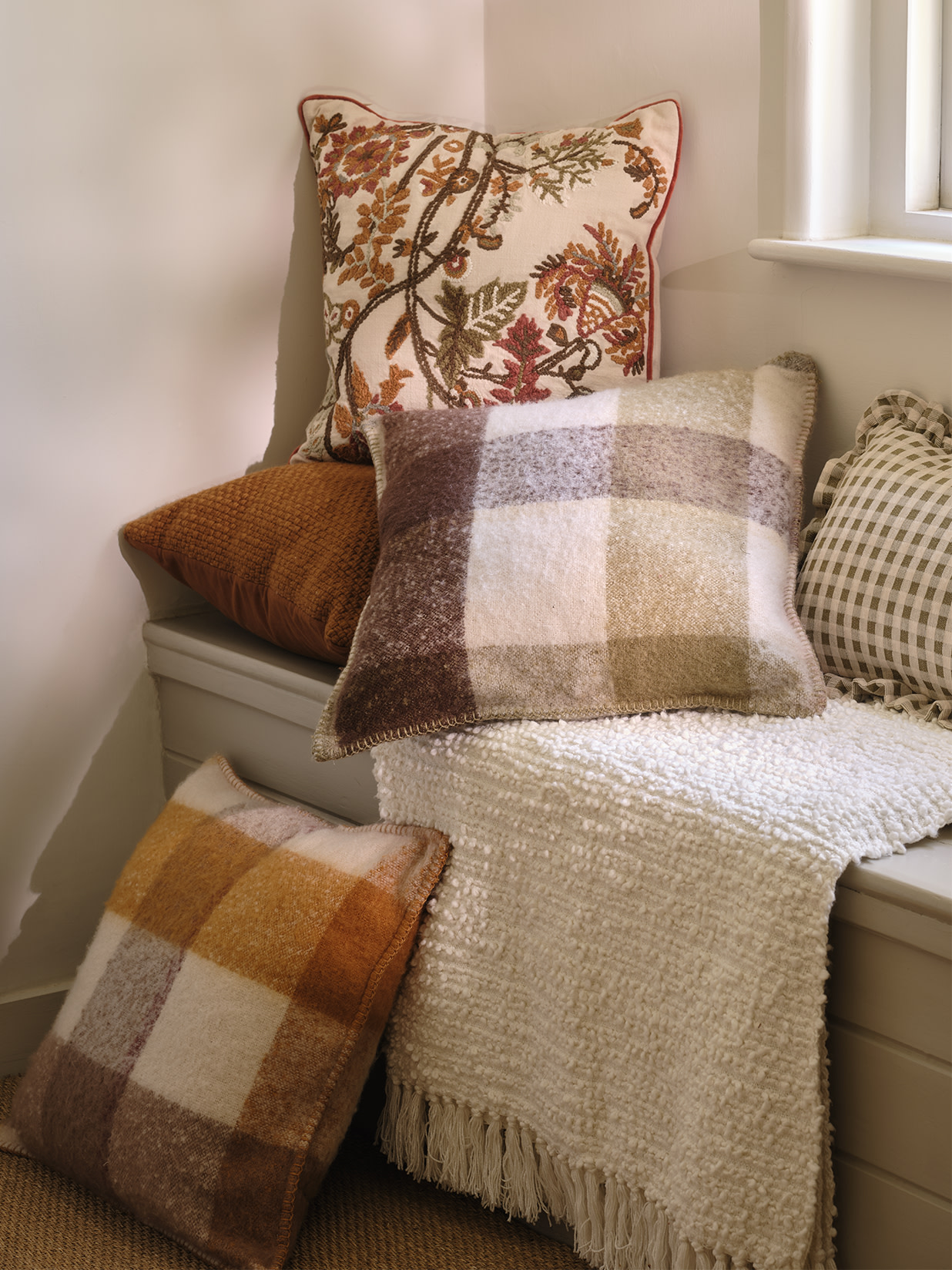 A group of cushions on a window seat