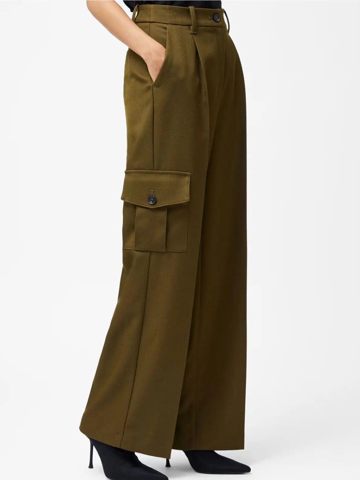 Woman wearing green cargo trousers and black heeled boots