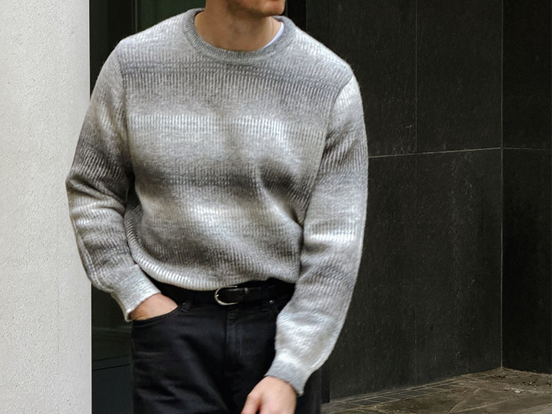 close up of man wearing grey jumper