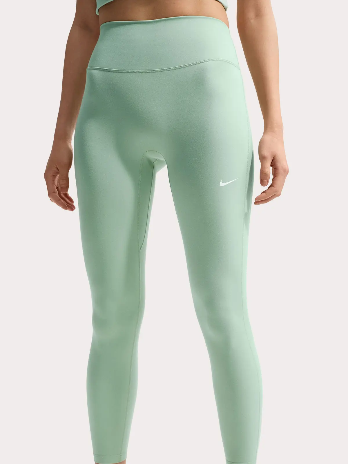 Woman wearing green leggings