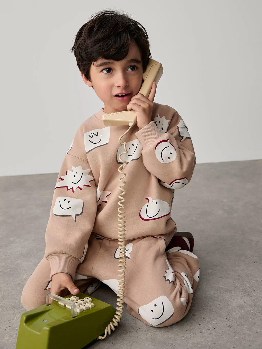 Child wearing matching printed sweatshirt and joggers