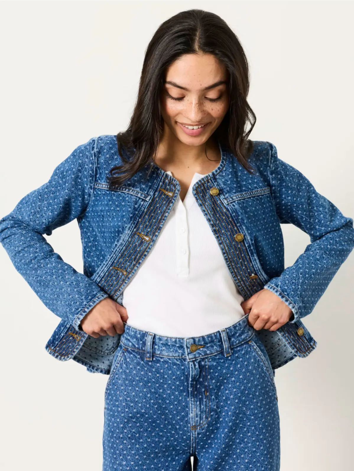 Woman wearing patterned blue denim jacket and matching jeans