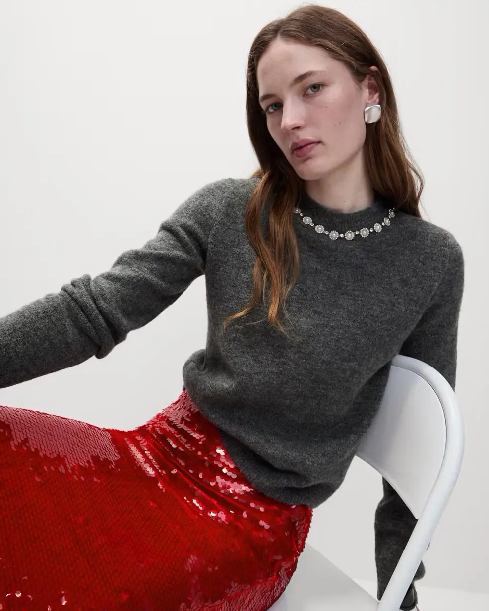 Woman wearing grey embellished jumper at M&S