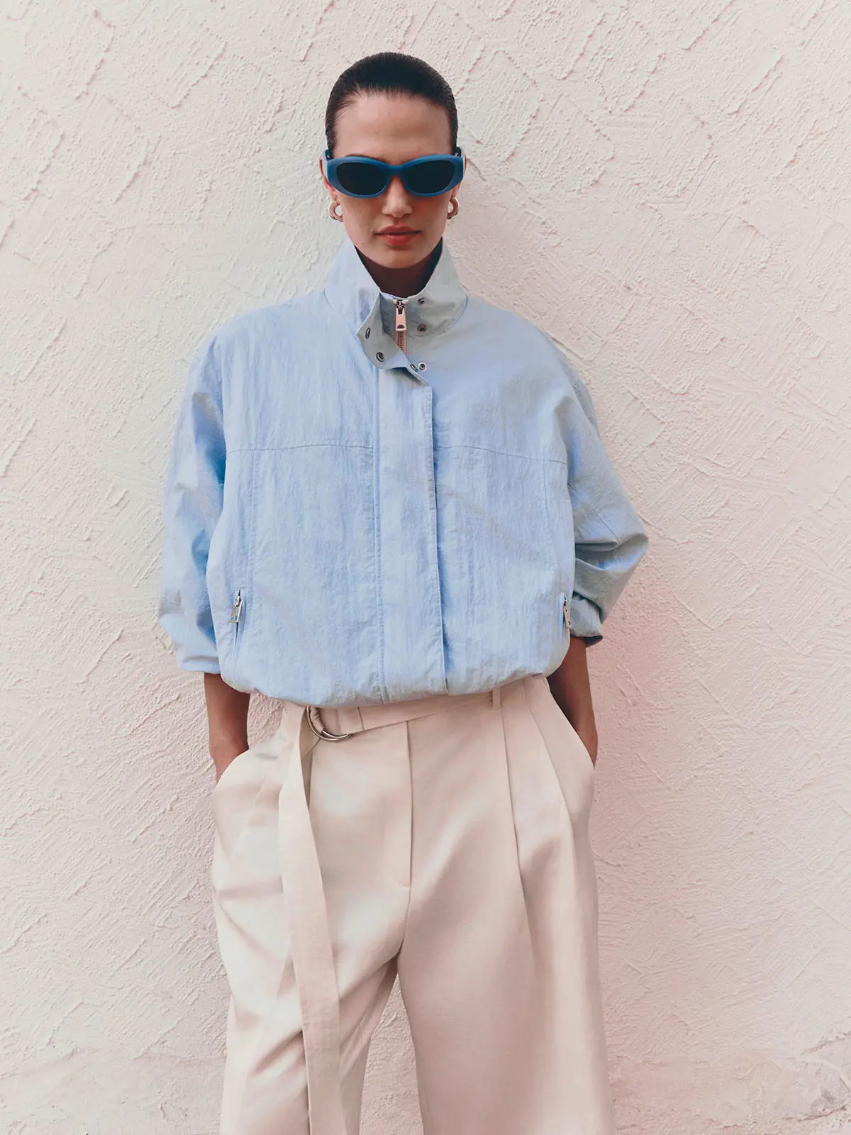 Woman wearing blue jacket and tailored shorts