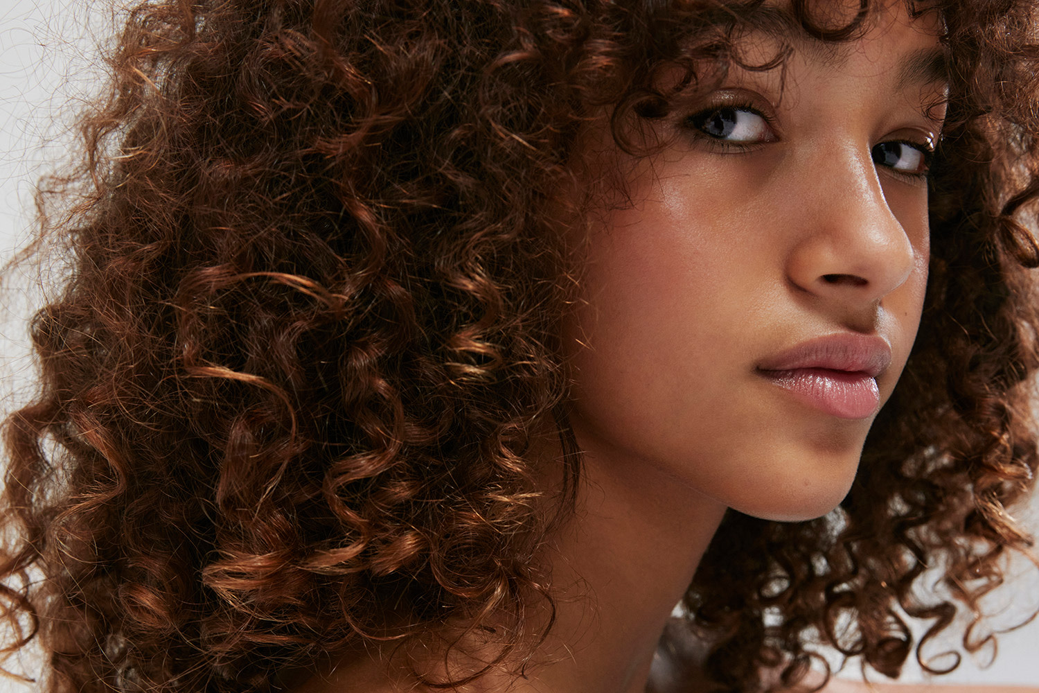 Teenage girl smiling. Book a first bra fit