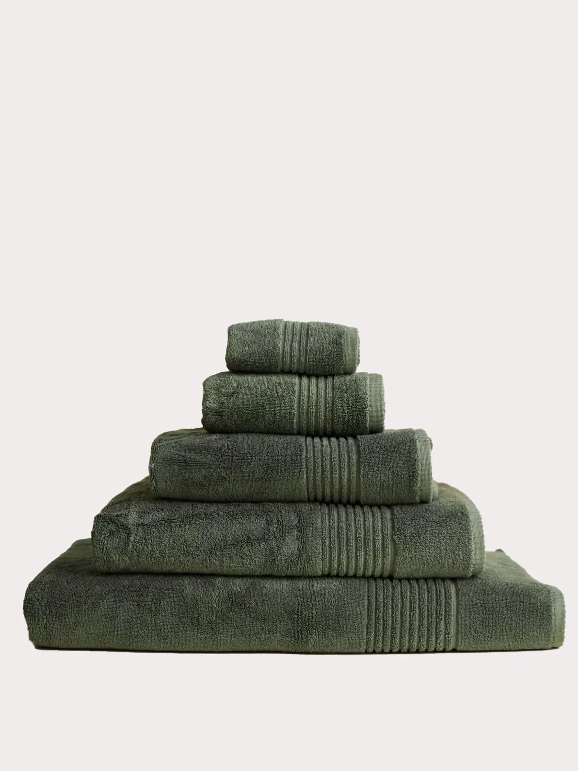 Pile of green towels in different sizes