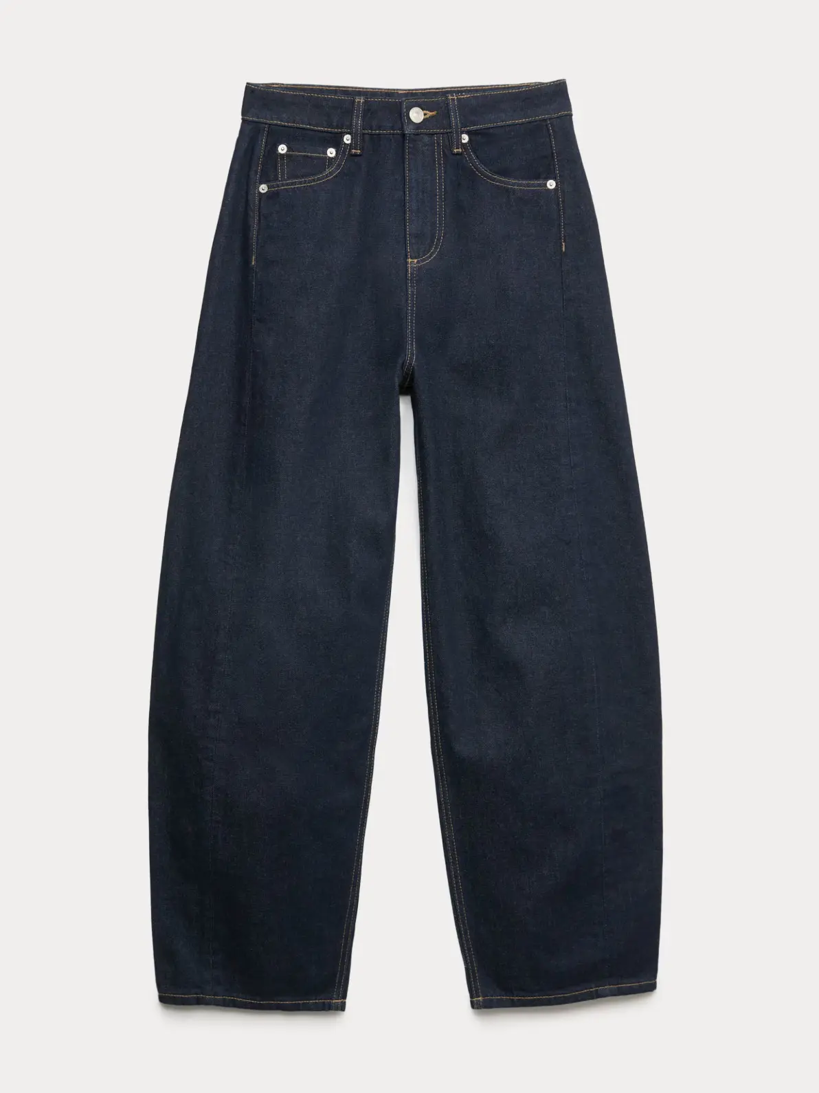 A pair of dark indigo barrel-leg jeans