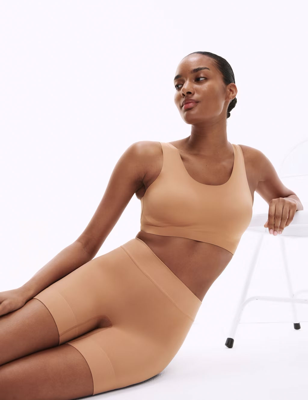 Woman wearing neutral-toned cropped top and anti-chafe shorts