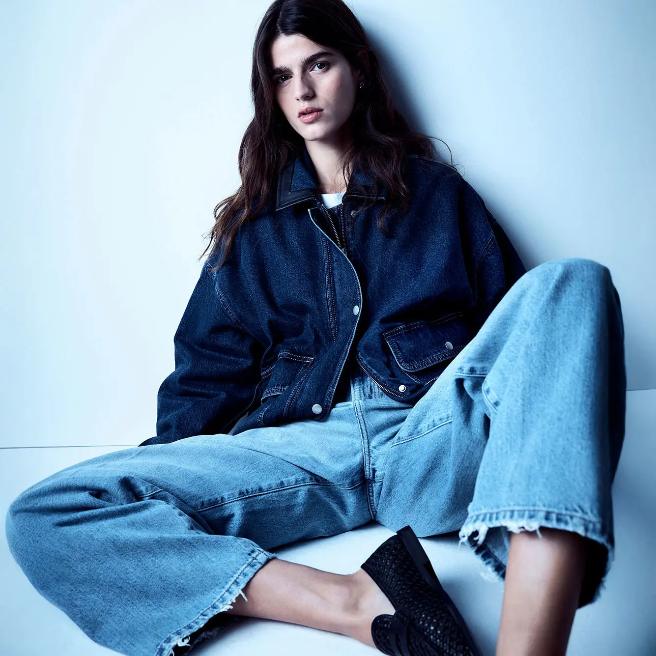 Woman wearing barrel-leg jeans and a dark blue denim jacket