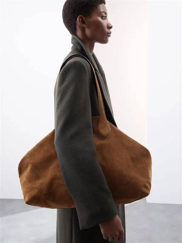 Woman carrying suede brown tote bag