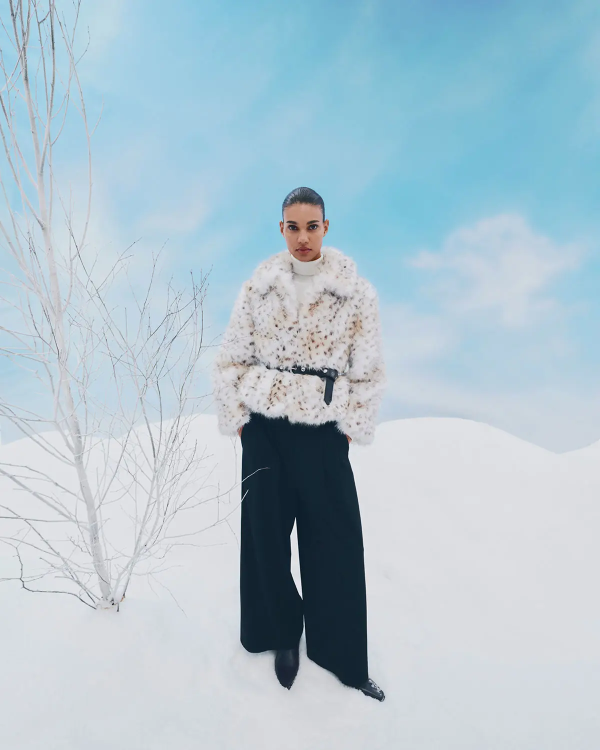 Woman wearing cream faux fur jacket