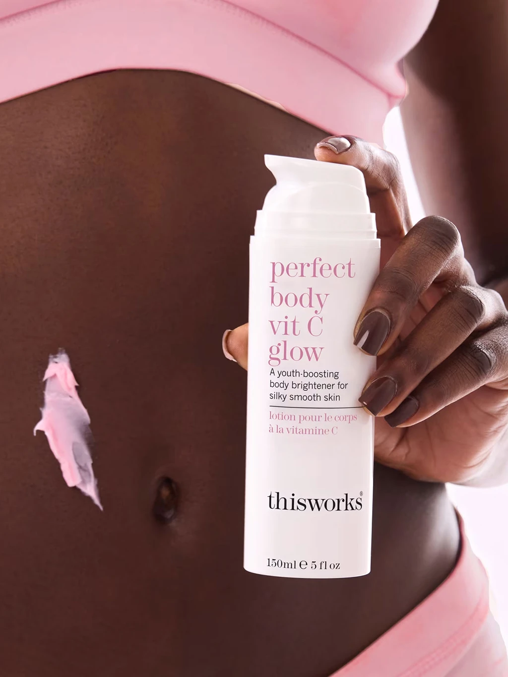 Woman holding ThisWorks Vit C Glow lotion
