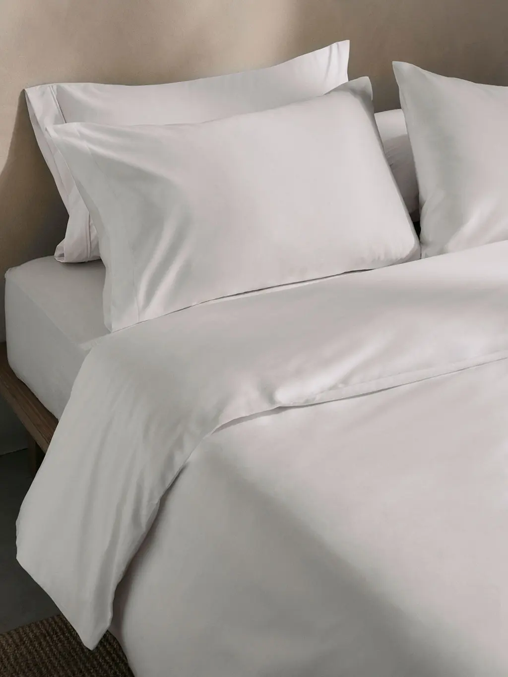 White bed with duvet and pillows