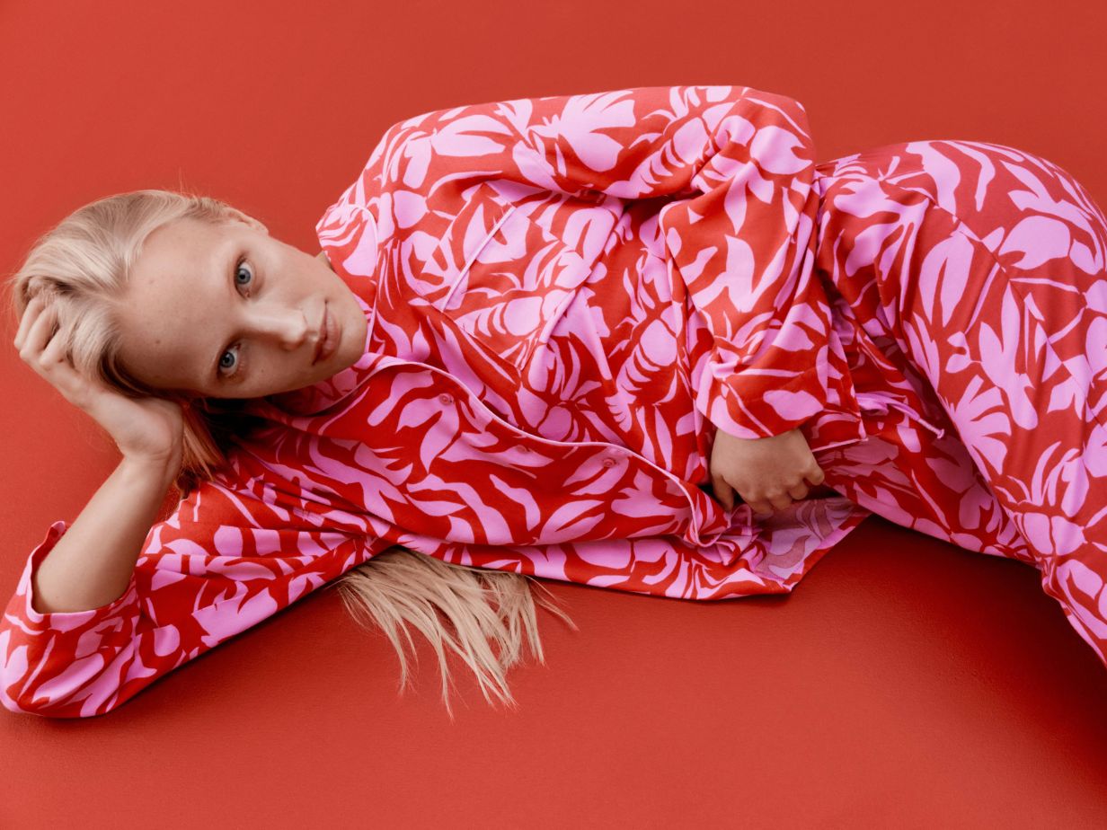 Woman wearing pink patterned pyjamas