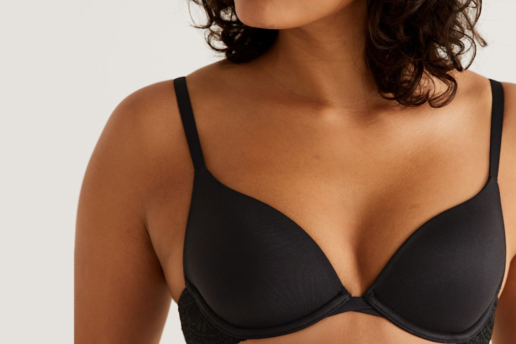 Woman wearing black bra. Shop bras