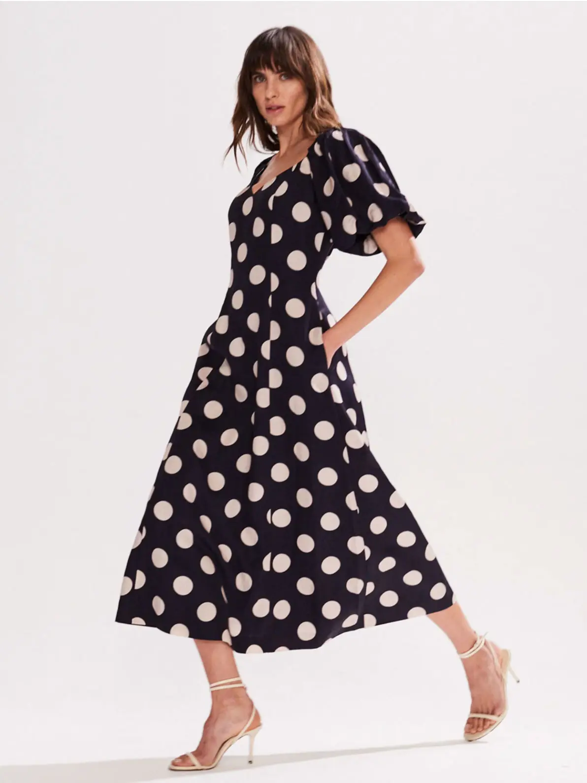 Woman wearing polka dot dress and heels 