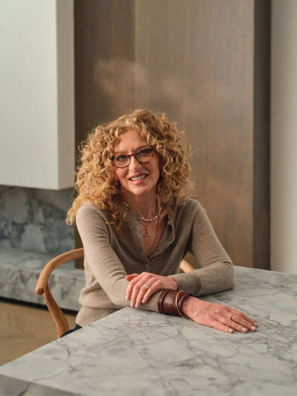 A shot of designer Kelly Hoppen sat at a tabel