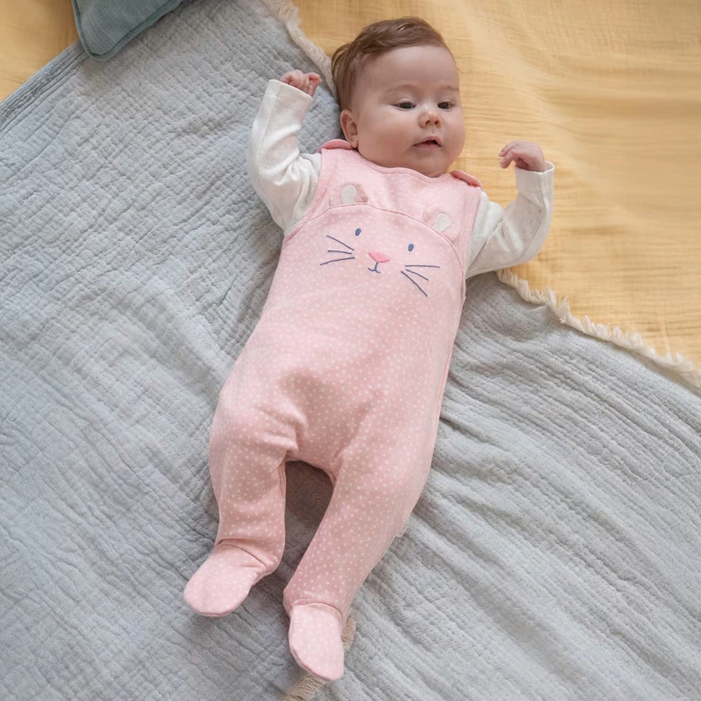 Baby wearing light pink mouse babygrow