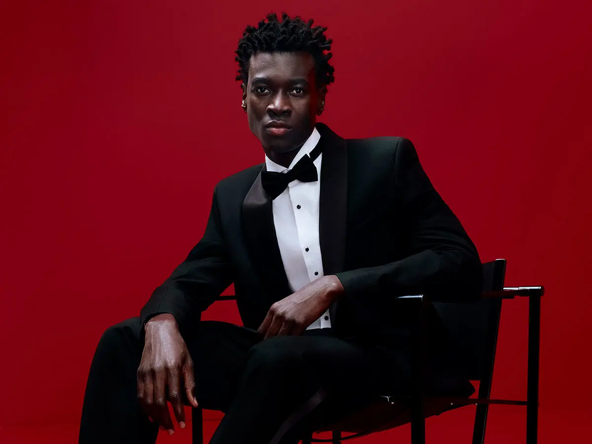 Man wearing smart black suit and black bow tie