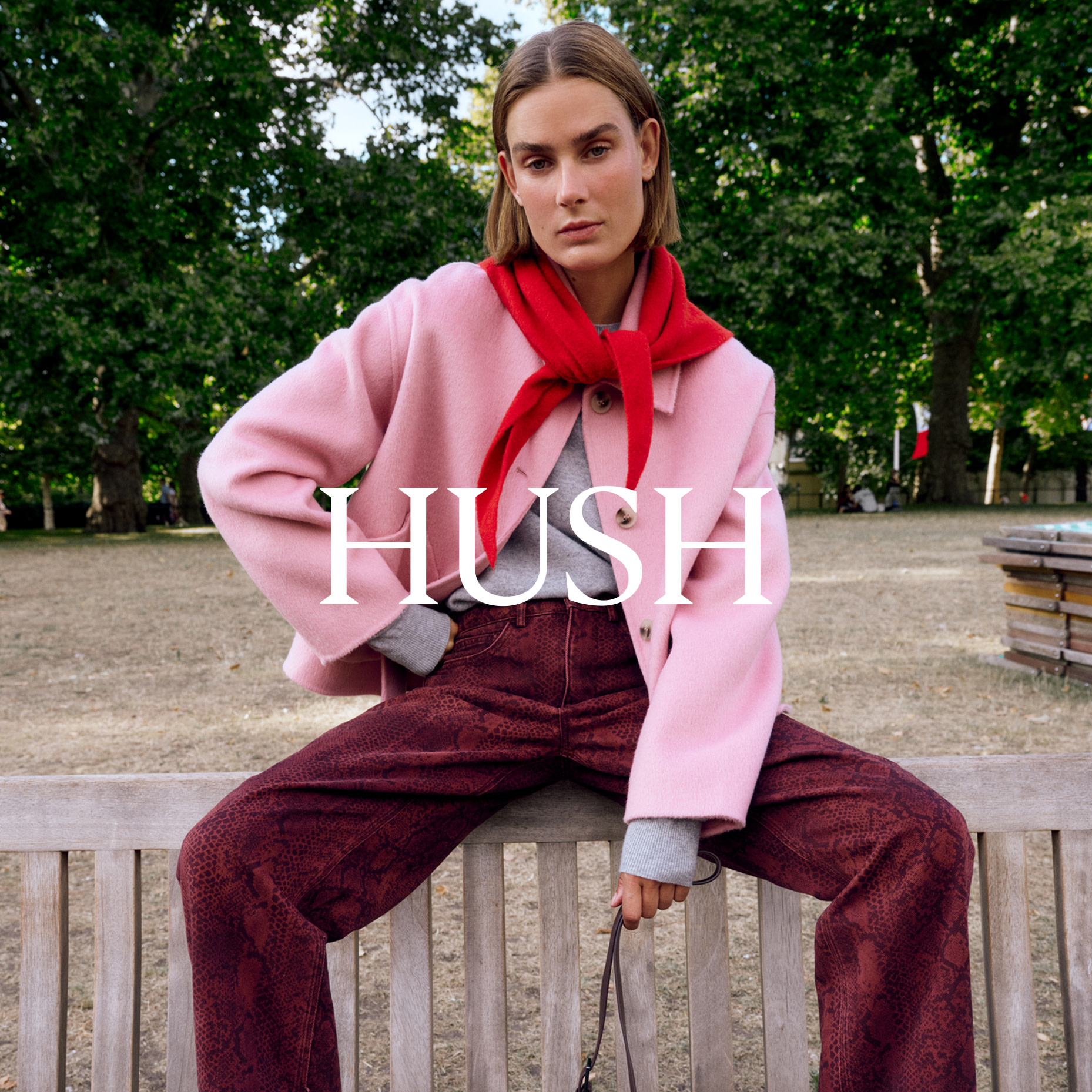 Woman wearing red neckerchief, pink jacket and burgundy trousers by Hush