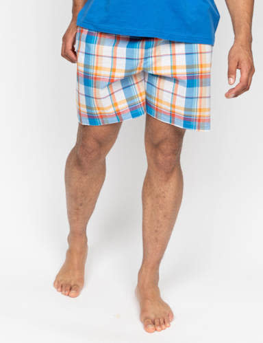 Man wearing checked pyjama shorts