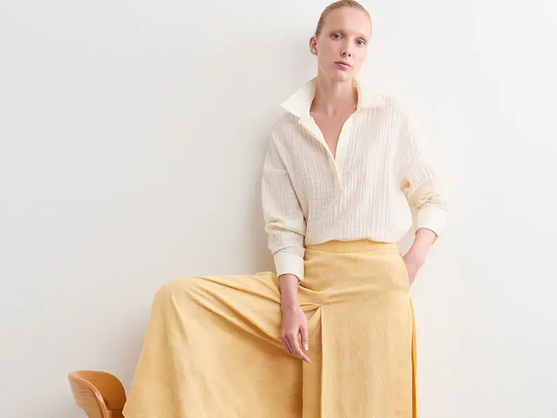 Woman in white top and yellow trousers