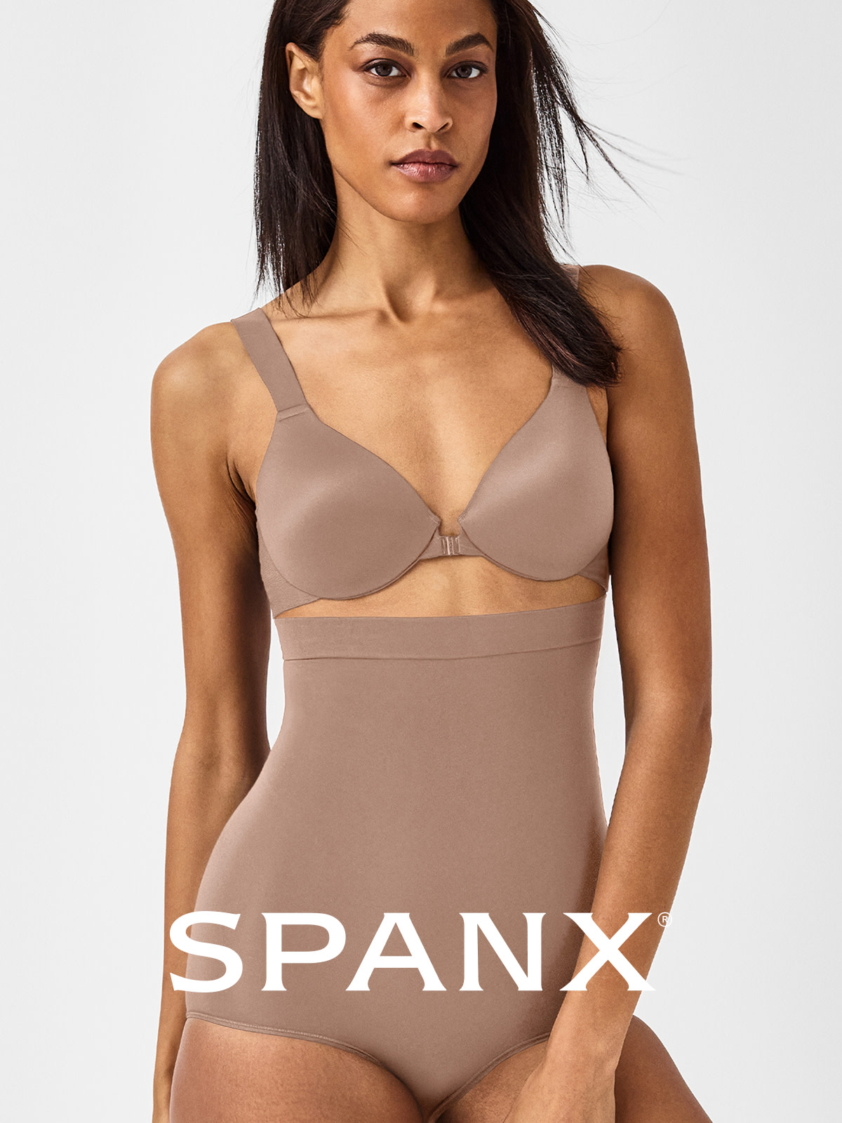 Woman wearing bra and shapewear by Spanx