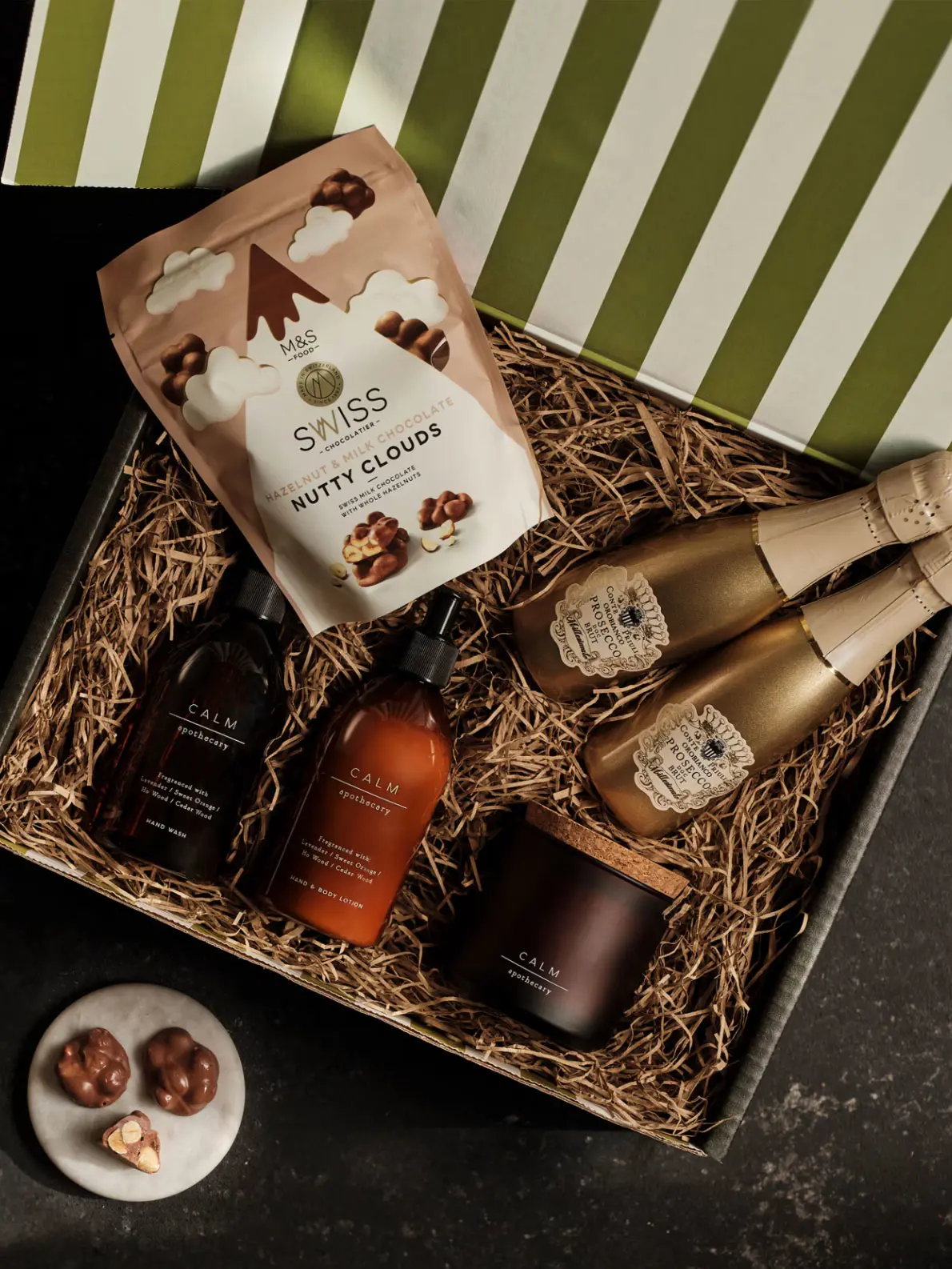 Gift box with an assortment of chocolates, alcoholic drinks, candles and beauty products