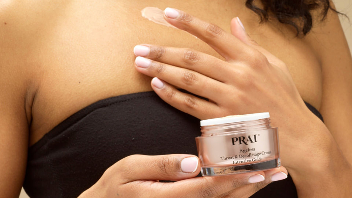 Woman putting lotion on chest