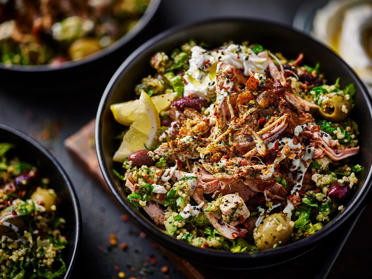 Chicken shawarma bowl with slices of lemon