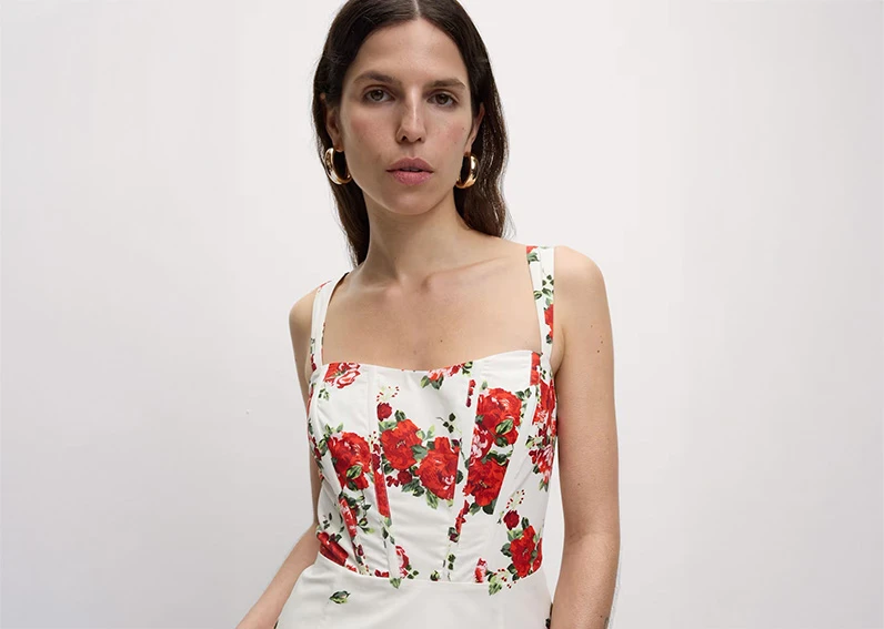 Woman wearing white and red floral dress to an engagement party