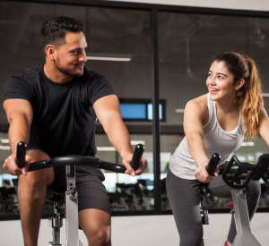 Indoor Cycling Instructor helping client at a gym
