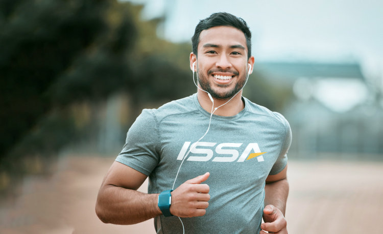 ISSA Trainer running with earbuds in