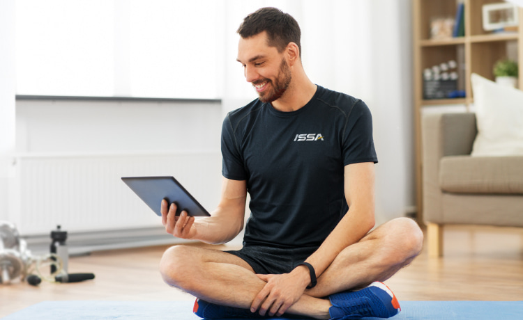 ISSA trainer using his tablet to upload a training session
