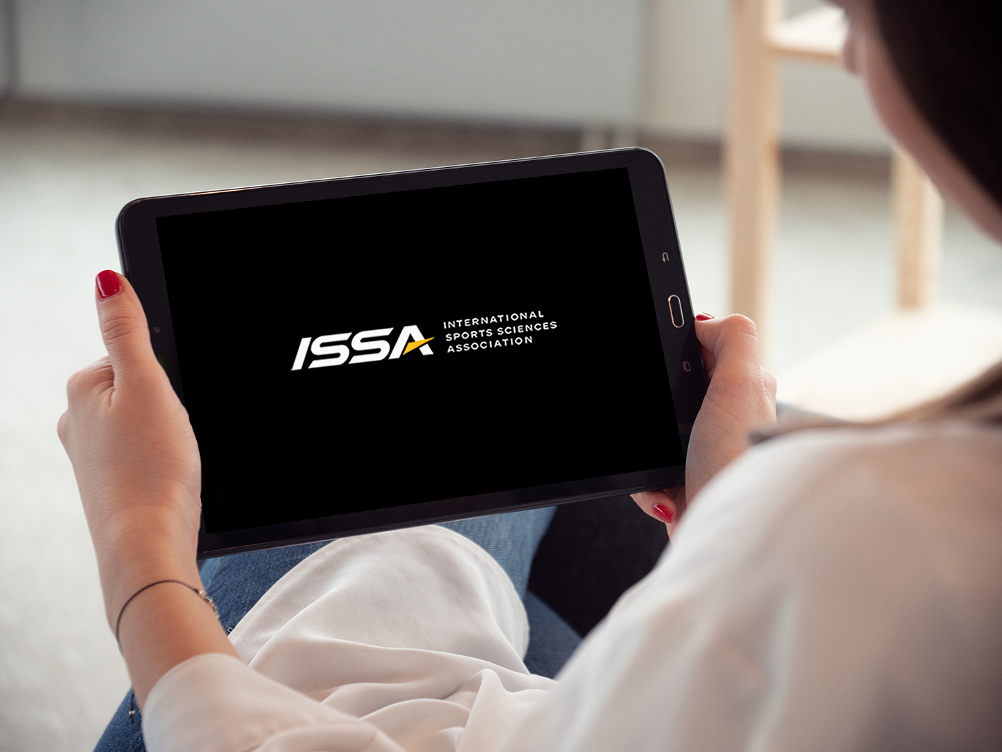 Woman Holding a tablet getting ready to read an ISSA eBook