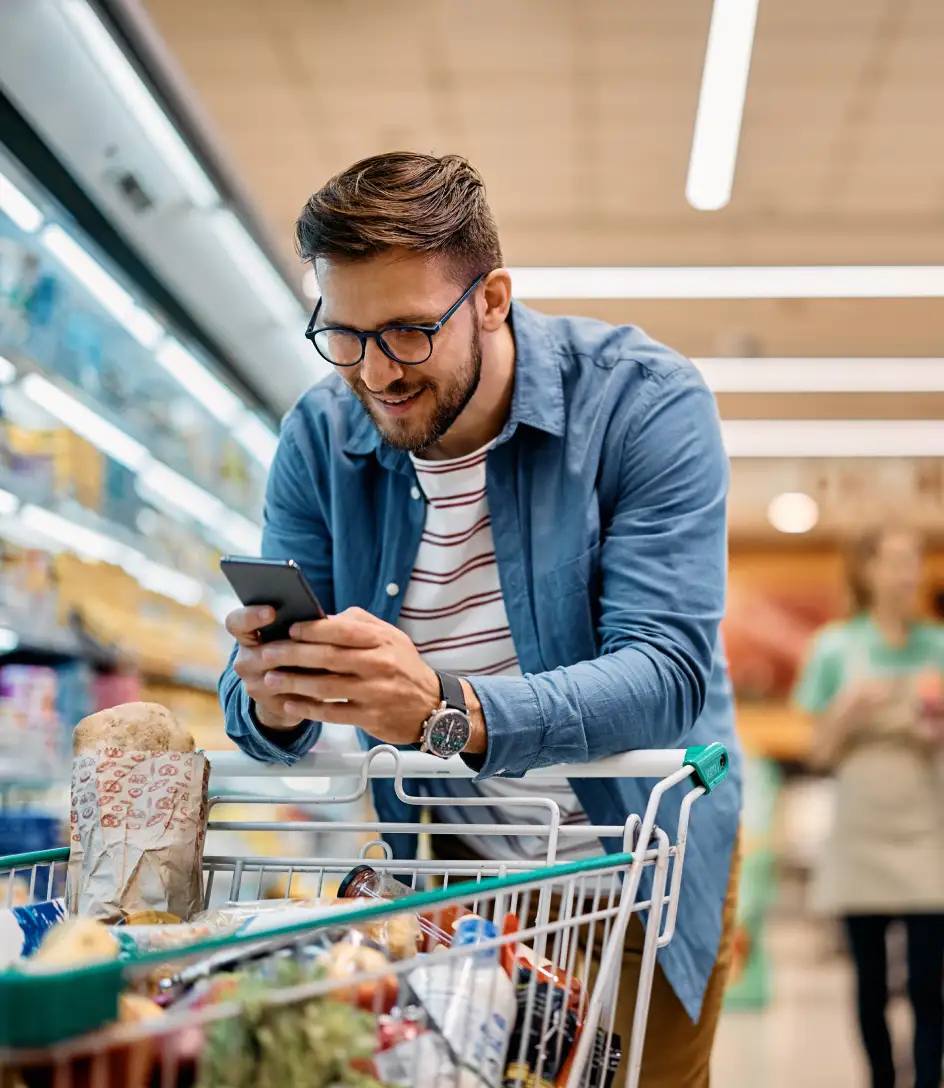 Man on his phone in a supermarket