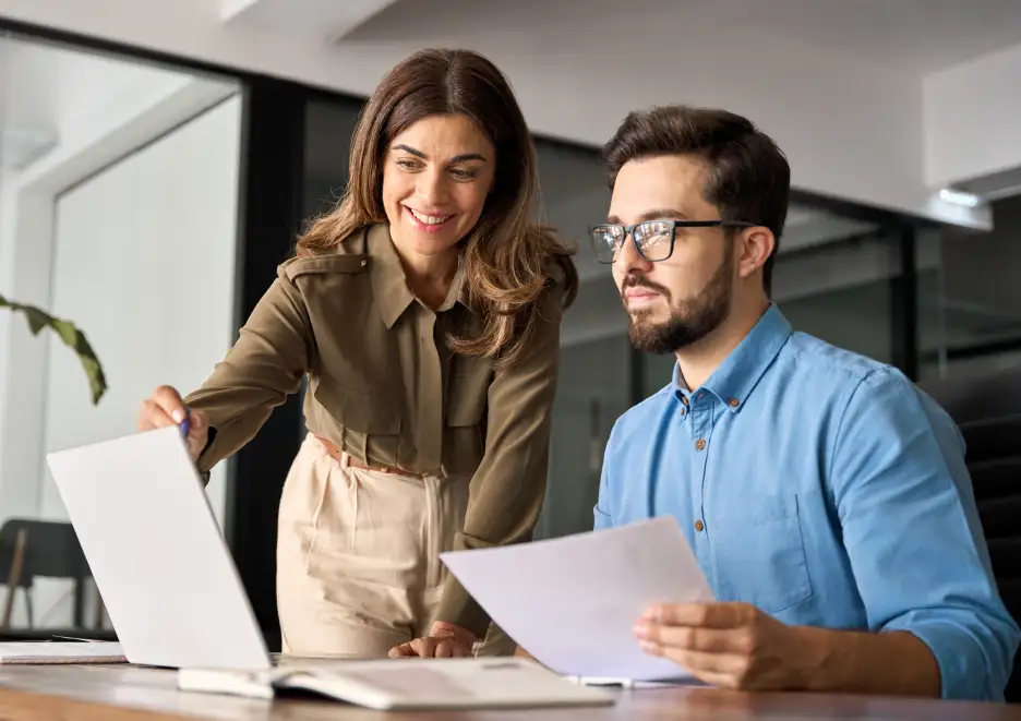 Two people looking at a laptop
