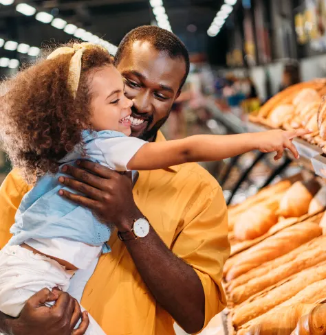 Man with a child in the bakery aisle