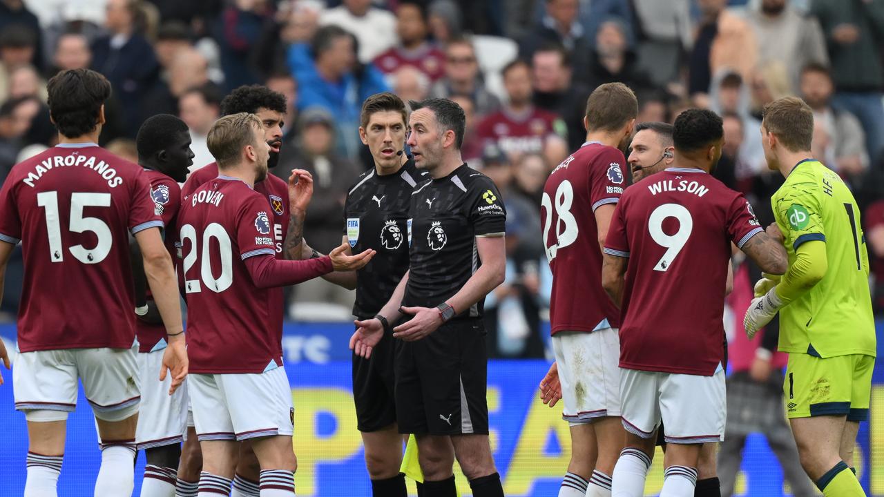 West Ham players discuss the disallowed goal with referee Chris Kavanagh after the loss to Arsenal