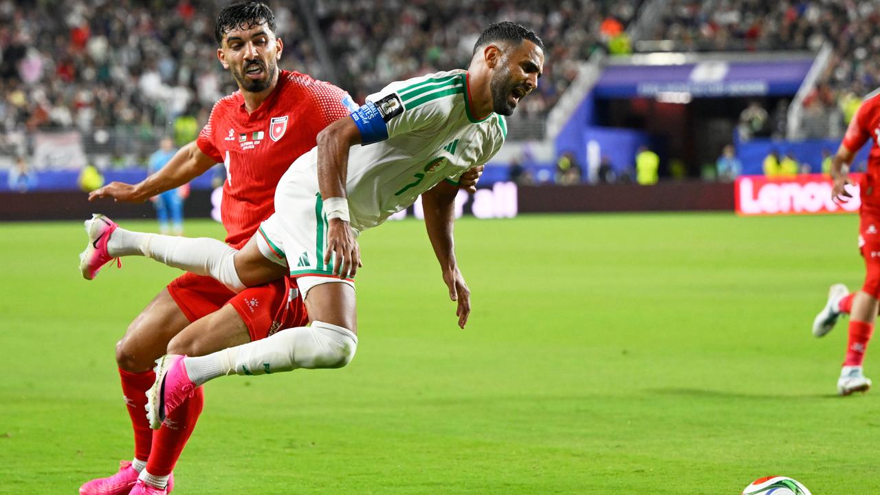 Algeria skipper Riyad Mahrez is upended by Jordan's Husam Abudahab in their clash