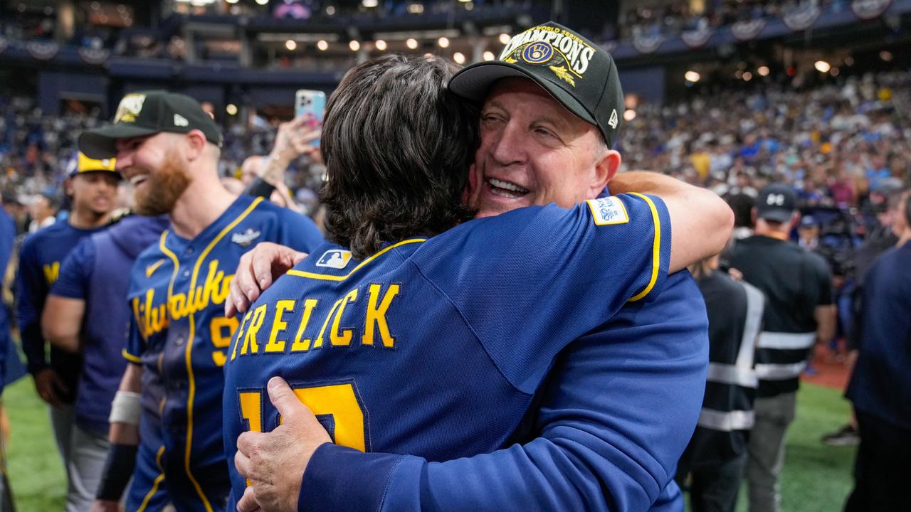 Milwaukee manager Pat Murphy hugs right fielder Sal Frelick
