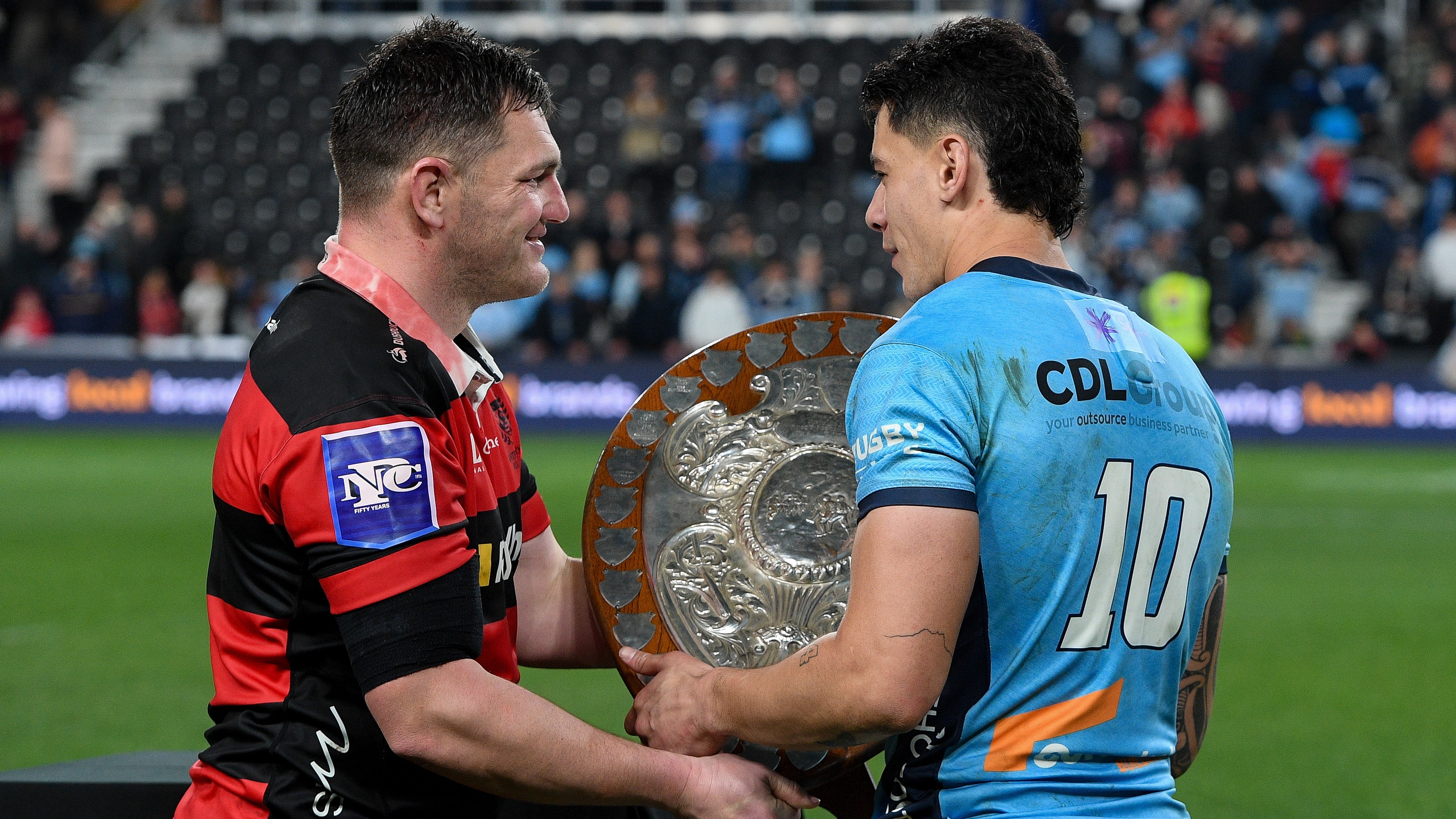 Canterbury's Brodie McAlister hands the Ranfurly Shield over to Northland's Rivez Reihana 