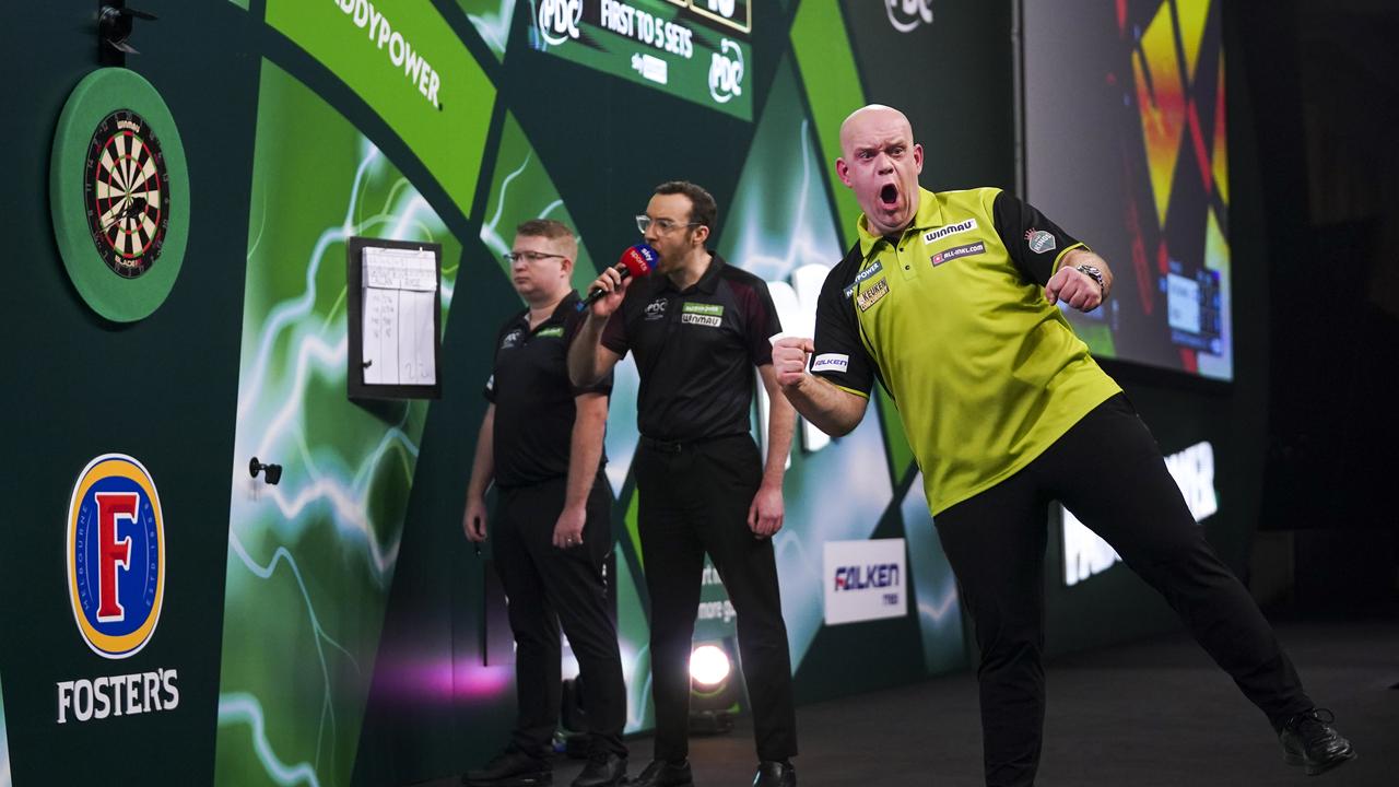 Michael Van Gerwen celebrates after winning his quarter-final in London.