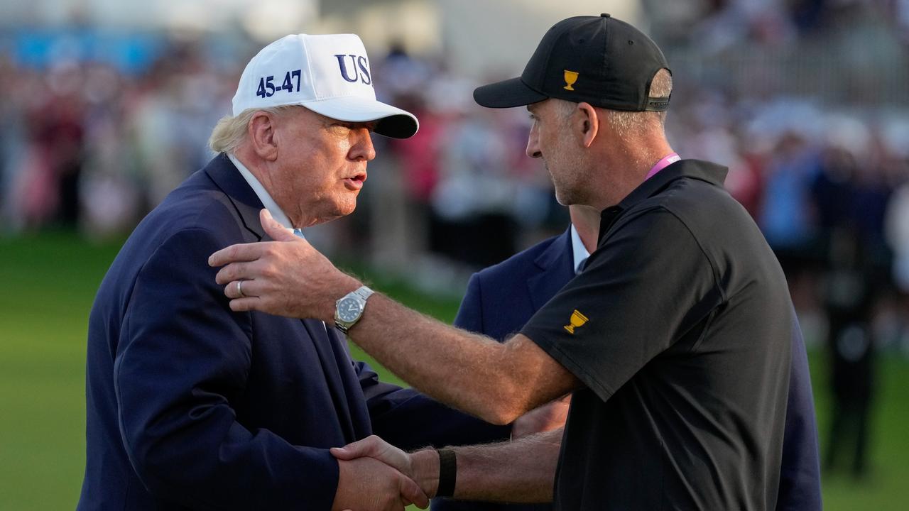 US President Donald Trump greets International team captain Geoff Ogilvy