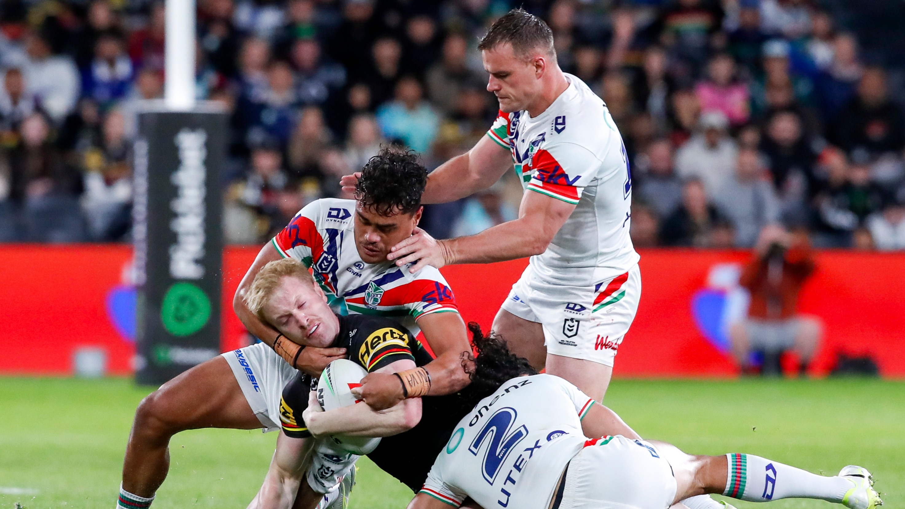 Jacob Laban, Jackson Ford and Dallin Watene-Zelezniak tackle Thomas Jenkins