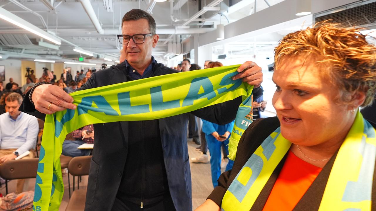 Heimo Schirgi and North Texas organising committee president Monica Paul check out fan scarves