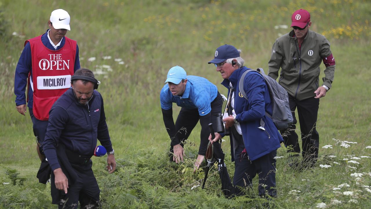 Rory McIlroy looks for his ball in the rough on the first hole at the 2019 Open where he made an eight
