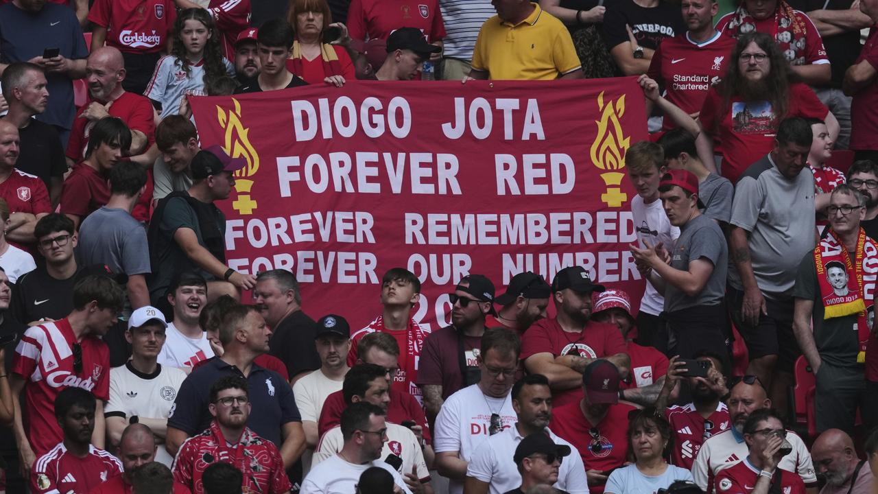 Liverpool fans hold a banner in the memory of Diogo Jota