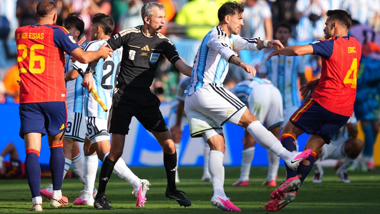 Leandro Paredes kicks at Eric Garcia as assistant referee Tomaz Klancnik tries to restore calm